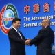 Chinese President Xi Jinping (L) shakes hands with South African President Jacob Zuma during the opening ceremony of the Johannesburg Summit of the Forum