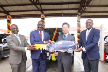 Ugandan officials and Chinese Ambassador to Uganda Zhang Lizhong (2nd R) attend a hand-over ceremony of SUV vehicles in Kampala