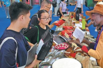 Visitors to the third China-Africa Economic and Trade Expo select products from Africa at the exhibition held in Changsha, Hunan Province, China