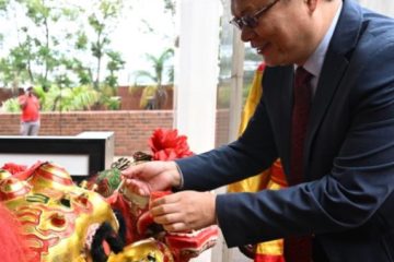 Chinese Ambassador to Zimbabwe Zhou Ding paints the eyes of a lion dance prop during a Spring Festival celebration in Harare, Zimbabwe