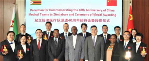 Members of the Chinese medical team pose for a group photo with Chinese and Zimbabwean officials at the Chinese embassy in Harare, Zimbabwe