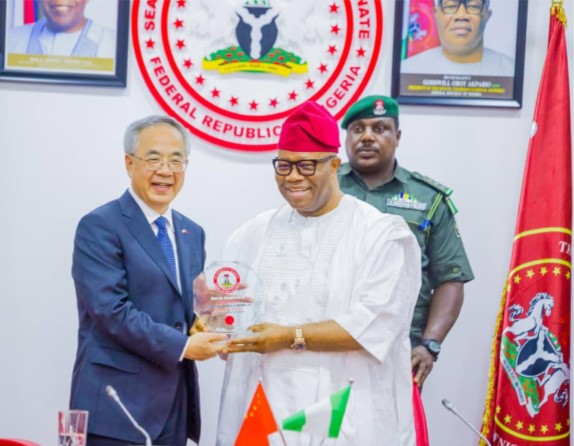 Hu Chunchua with the President of the Senate, Godswill Akpabio 
