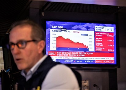 A trader works on the floor of the New York Stock Exchange in New York, the United States