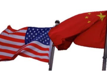 Chinese and U.S. flags flutter are seen outside the building of an American company in Beijing