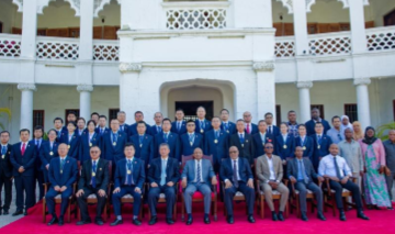Hussein Ali Mwinyi (C front), president of Tanzania's Zanzibar, poses for a group photo after awarding medals to members of the 34th batch of the Chinese medical team and experts from the China-aided schistosomiasis control project for their distinguished service in improving healthcare in the Zanzibar Archipelago, in Zanzibar, Tanzania