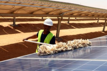 A worker cleans solar panels at the Benban Solar Energy Park in Aswan, Egypt