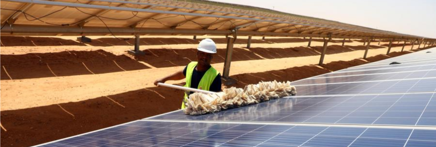 A worker cleans solar panels at the Benban Solar Energy Park in Aswan, Egypt