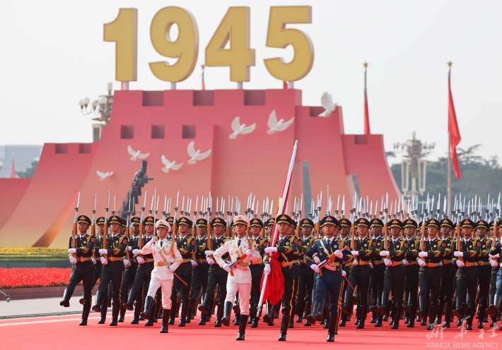 Honour guards escort the Chinese national flag during a grand gathering to mark the 80th anniversary of the victory in the Chinese People's War of Resistance against Japanese Aggression and the World Anti-Fascist War in Beijing, capital of China