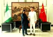 Ambassador Yu Dunhai in handshake with Mr. Tegbe, former DG, NCSP