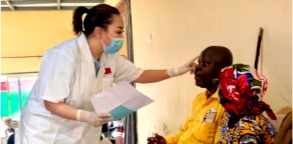Chinese ophthalmologist (L) checking a patient in Bujumbura, Burundi